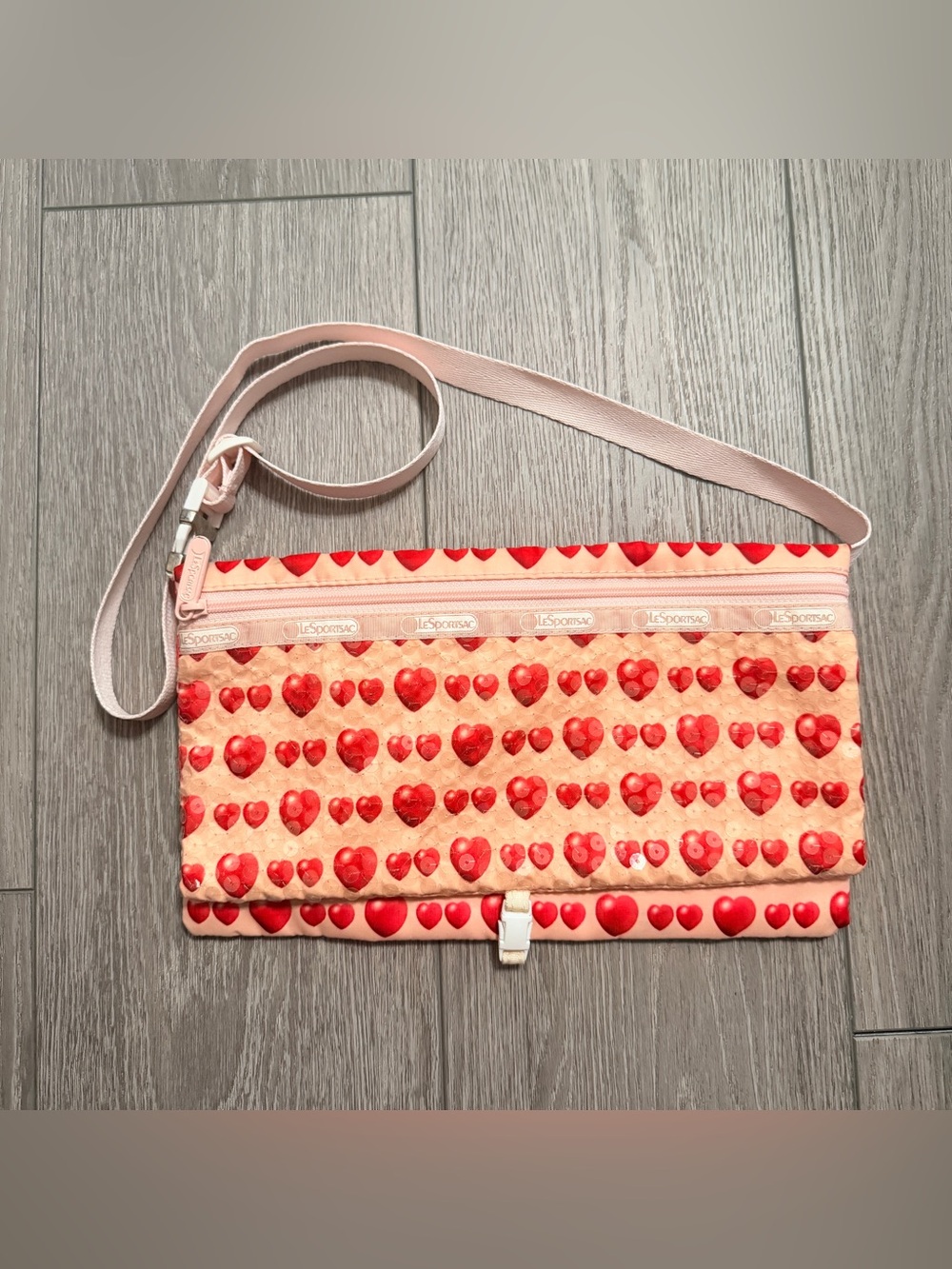 LeSportsac shoulder bag adorned with charming rows of sparkling red sequin heart